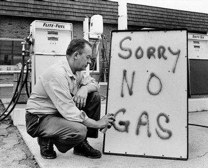 June 1 1973 Leon Mill spray paints a sign outside his Phillips 66 station